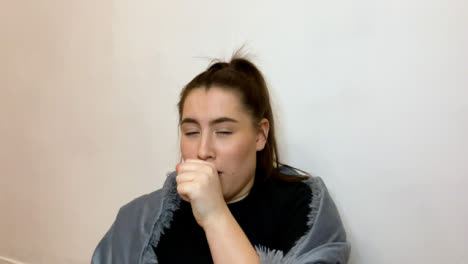 Young-Female-Student-Looking-Visibly-Unwell-Coughing-Whilst-Talking-to-Camera-On-Video-Call