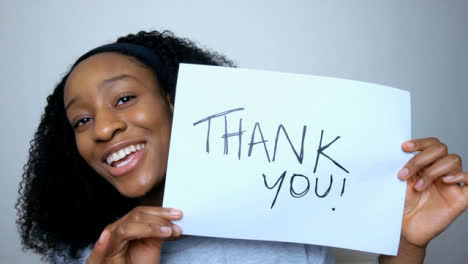 Young-Student-Holding-Up-Thank-You-Sign-During-Video-Lecture