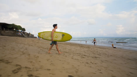 Tracking-Shot-Following-Young-Surfer-Walking-Towards-Waves