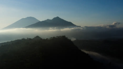 Drone-Shot-Rising-Up-and-Looking-at-Mount-Batur-In-Distance