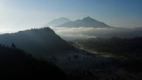 Drone-Shot-Rising-Above-Trees-Looking-Towards-Mount-Batur-