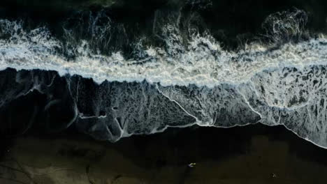 Drone-Shot-Ascending-Above-Waves-at-Pigstone-Black-Sand-Beach