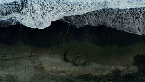 Drone-Shot-Descending-On-Motorcyclist-On-Pigstone-Beach