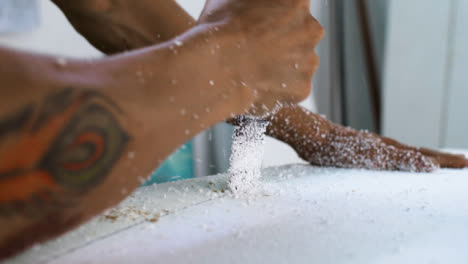 Handheld-Close-Up-Shot-of-Surfboard-Shaper-Cutting-Into-Polystyrene-Board