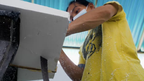 Handheld-Low-Angle-Shot-of-a-Surfboard-Shaper-Cutting-a-Polystyrene-Board