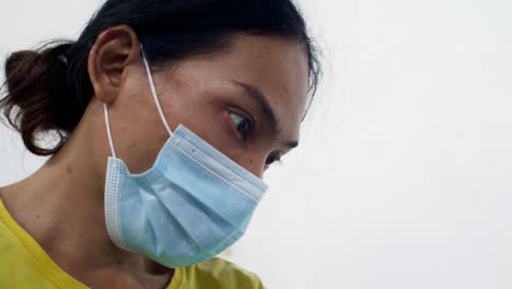 Handheld-Close-Up-Shot-of-Surboard-Shaper-Wearing-Face-Mask