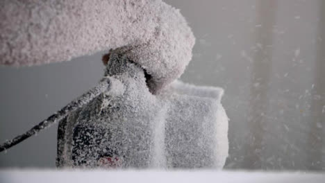 Handheld-Close-Up-Shot-of-Power-Tool-Being-Used-On-Polystyrene-Surfboard