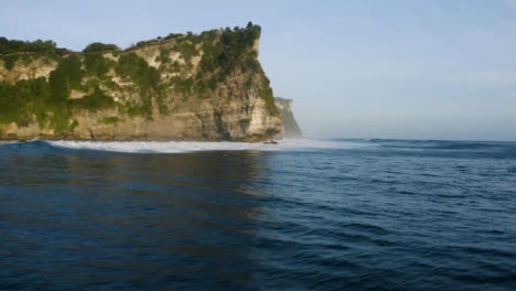 Drone-Shot-Flying-Over-Waves-at-Uluwatu-Coast