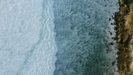 Drone-Shot-Looking-Down-at-Waves-at-Uluwatu-Coast