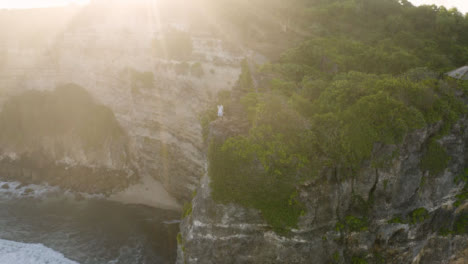 Drone-Shot-Orbiting-Person-Standing-On-Cliff-Edge-