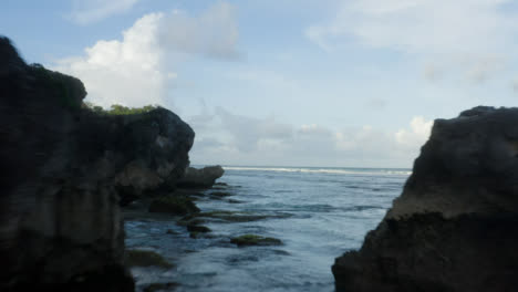 Drone-Shot-Flying-Between-Uluwatu-Coastal-Rocks-