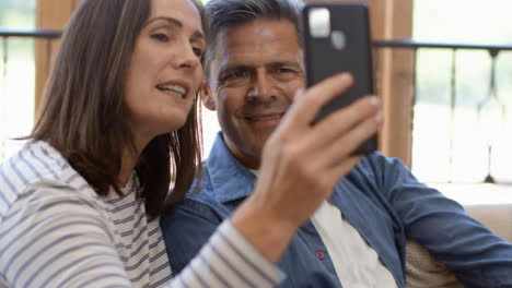Tracking-Shot-Approaching-Middle-Aged-Couple-Using-Smartphone-for-Video-Call
