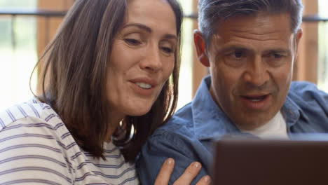 Close-Up-Shot-of-Middle-Aged-Couple-Talking-into-Laptop-During-Video-Call