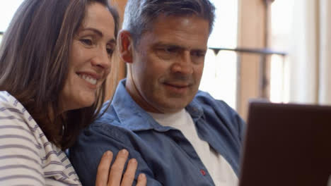 Close-Up-Shot-of-Middle-Aged-Couple-Talking-into-a-Laptop-During-Video-Call