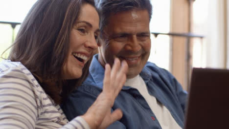 Close-Up-Shot-of-a-Middle-Aged-Couple-Talking-into-a-Laptop-During-Video-Call