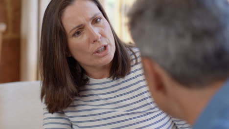 Over-the-Shoulder-Shot-of-a-Middle-Aged-Couple-Having-Heated-Discussion