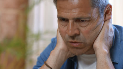 Close-Up-Shot-of-Middle-Aged-Man-Looking-Visibly-Concerned