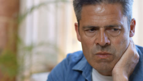 Close-Up-Shot-of-a-Middle-Aged-Man-Looking-Visibly-Concerned