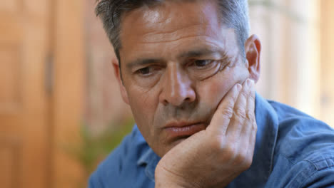 Close-Up-Shot-of-Middle-Aged-Man-Looking-Visibly-Stressed-and-Concerned