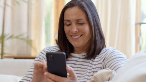 Close-Up-Shot-Revealing-Middle-Aged-Woman-Scrolling-On-Smartphone