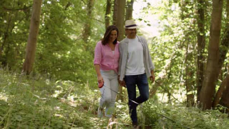 Wide-Shot-of-Middle-Aged-Couple-Walking-Through-Scenic-Woodland