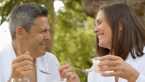 Close-Up-Shot-of-Middle-Aged-Couple-Eating-Yoghurt-During-Breakfast