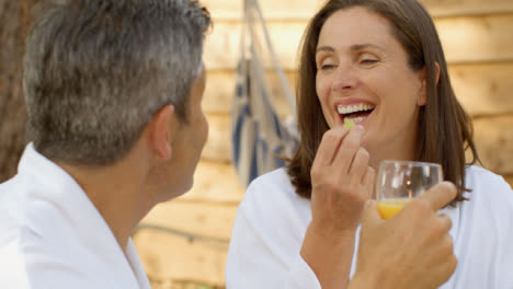 Close-Up-Shot-of-Middle-Aged-Couple-Drinking-Orange-Juice-During-Breakfast