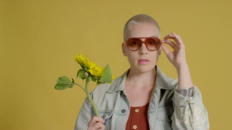 Portrait-Shot-of-a-Fashion-Model-Posing-to-Camera-with-Sunflower