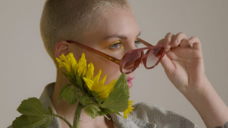 Close-Up-Shot-of-Model-Posing-with-Sunflower-for-Fashion-Shoot