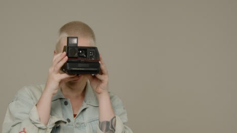 Close-Up-Shot-Approaching-Model-Using-Instant-Film-Camera