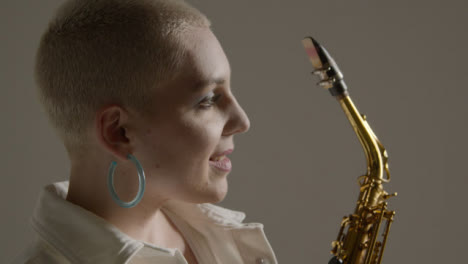 Close-Up-Shot-of-Model-Posing-with-an-Alto-Saxophone-