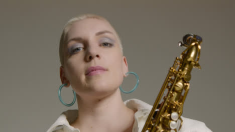 Low-Angle-Portrait-Shot-Looking-Up-at-Model-as-She-Poses-with-Saxophone