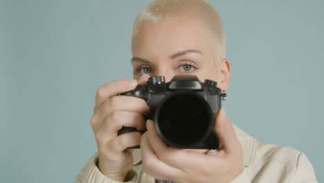 Photographer-poses-with-dslr-camera-02