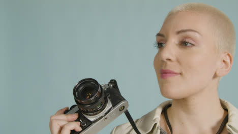 Female-photographer-poses-with-vintage-camera-01