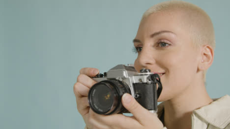 Female-photographer-poses-with-vintage-camera-02