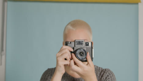 Female-photographer-poses-with-vintage-camera-07