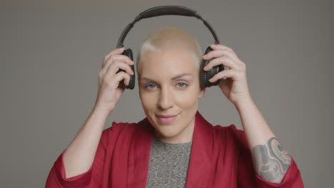 Female-model-placing-headphones-on-her-head