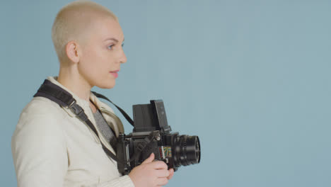 Side-view-of-female-photographer-using-medium-format-film-camera-01