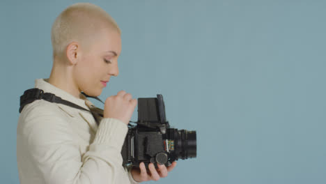 Side-view-of-female-photographer-using-medium-format-film-camera-03