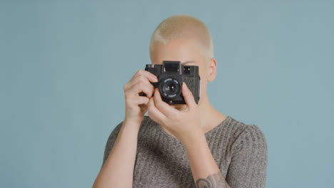 Female-caucasian-photographer-posing-with-retro-camera-01