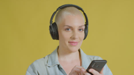 Female-caucasian-model-listening-to-music-on-headphones-studio-portrait-05
