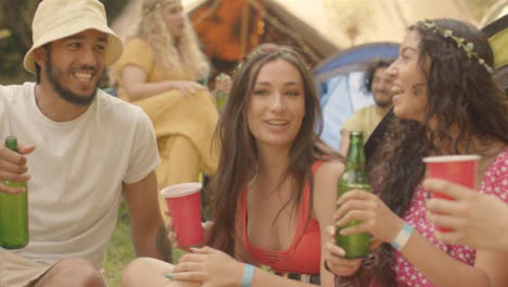 Tracking-Shot-Around-Group-of-Young-Festival-Goers-as-One-Brings-Drinks-Over