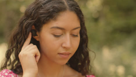 Nahaufnahme-Einer-Jungen-Frau,-Die-Drahtlose-Kopfhörer-In-Ihre-Ohren-Steckt?