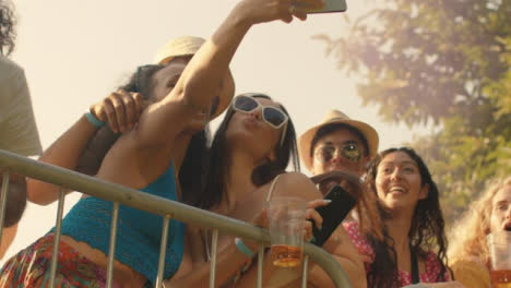 Low-Angle-Shot-of-Young-Festival-Goers-at-a-Stage-Barrier-the-Enjoying-Music
