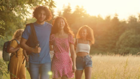 Tracking-Shot-of-Multi-Ethnic-Group-of-Friends-Walking-at-Sunset