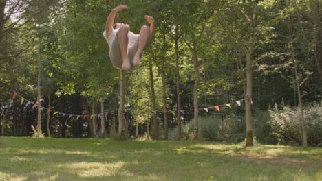 Wide-Shot-of-Athletic-Young-Man-Doing-Backflip