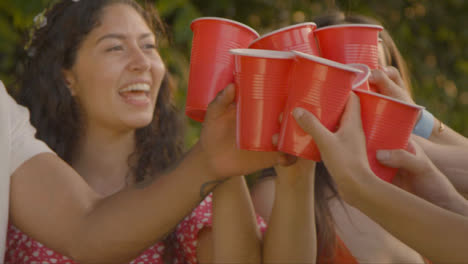 Medium-Shot-of-Group-of-Friends-Bringing-Drinks-Together-In-Toast