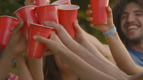 Close-Up-Shot-of-Group-of-Friends-Bringing-Drinks-Together-In-a-Toast