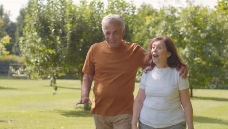 Tracking-Shot-of-Senior-Couple-Walking-Through-Lush-Gardens-02