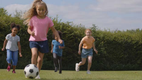 Tracking-Shot-of-Group-of-Children-Playing-Football-01